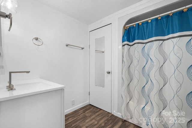 full bath featuring vanity, wood finished floors, and crown molding