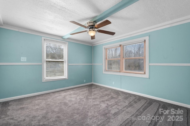 spare room featuring baseboards, carpet flooring, a textured ceiling, and ceiling fan