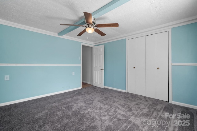 unfurnished bedroom with a closet, a textured ceiling, and carpet