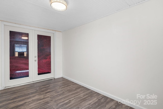 unfurnished room featuring french doors, baseboards, and dark wood-type flooring