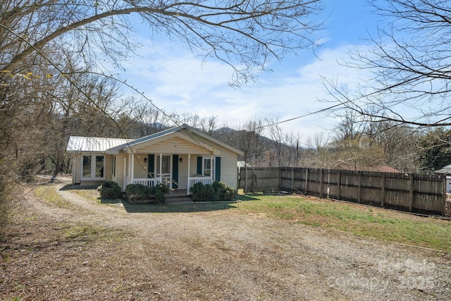 exterior space featuring fence and covered porch