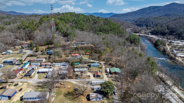 aerial view with a mountain view and a wooded view