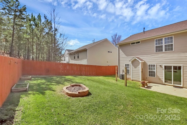 view of yard with an outdoor fire pit, a patio area, and a fenced backyard