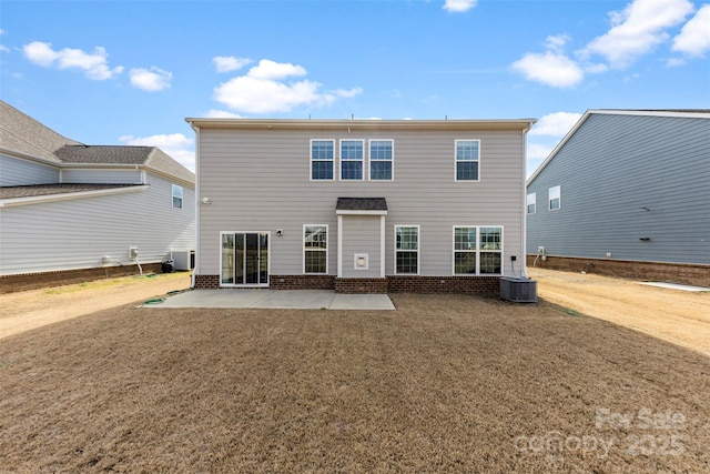 rear view of property with central AC, a patio, and a lawn