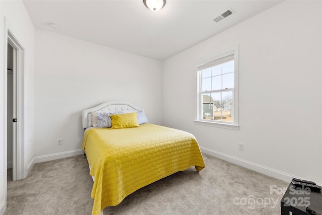 carpeted bedroom featuring visible vents and baseboards