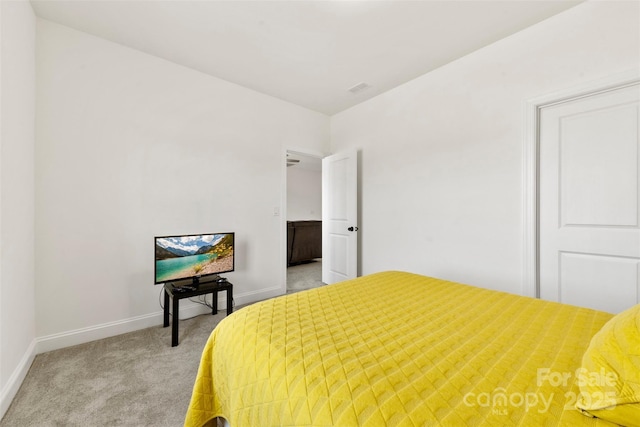 bedroom featuring baseboards, visible vents, and light colored carpet