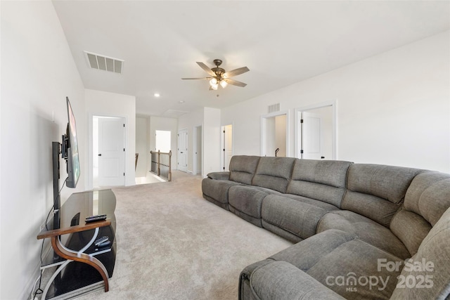 carpeted living area featuring a ceiling fan and visible vents