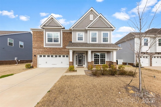 craftsman-style house featuring driveway, an attached garage, and brick siding