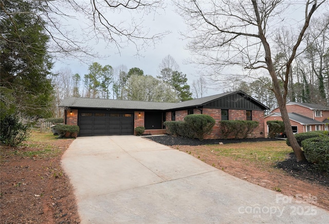 view of front of house featuring brick siding, board and batten siding, an attached garage, and concrete driveway