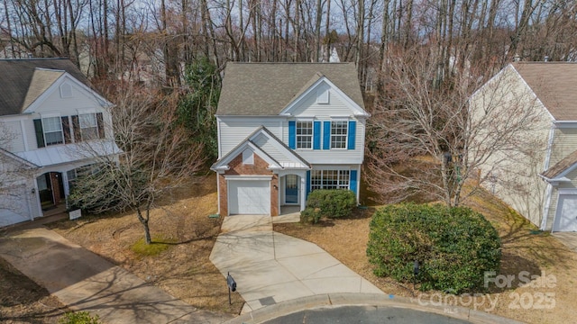 traditional-style home with concrete driveway and brick siding