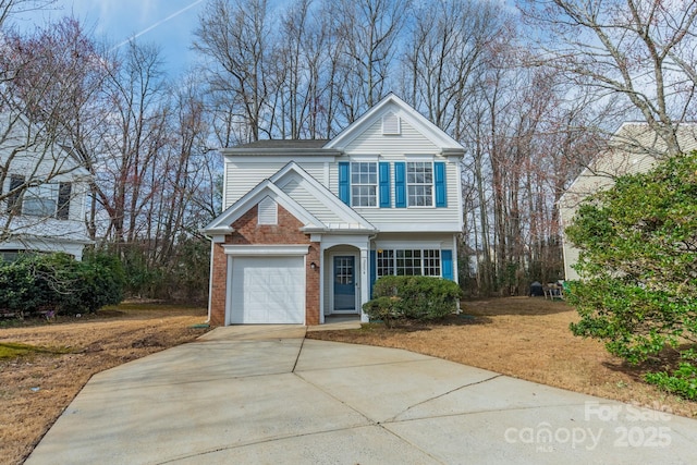 traditional home featuring concrete driveway and brick siding