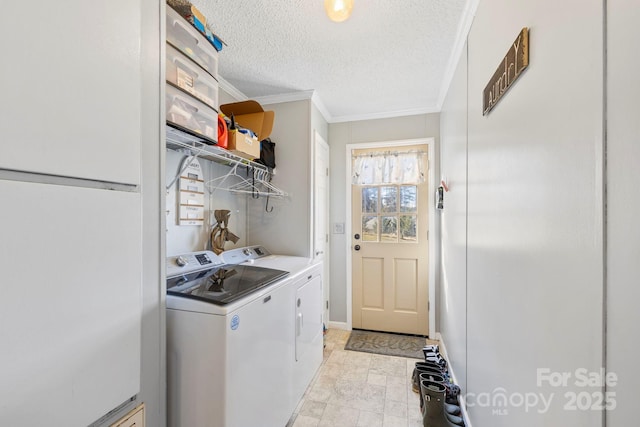 laundry room featuring washer and dryer, laundry area, crown molding, and a textured ceiling