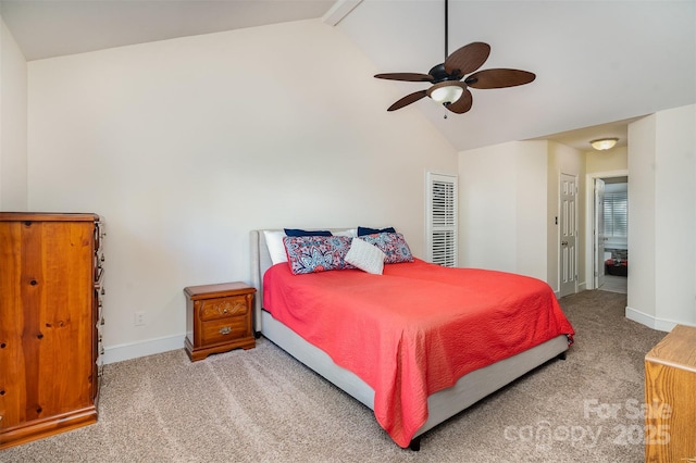 carpeted bedroom with a ceiling fan, lofted ceiling with beams, and baseboards