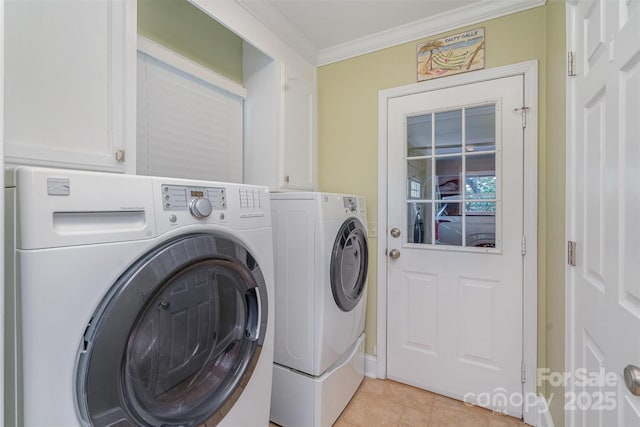 clothes washing area featuring washer and clothes dryer, cabinet space, crown molding, and light tile patterned flooring