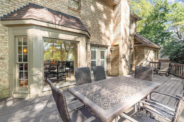 wooden deck with outdoor dining area