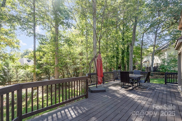 wooden terrace with outdoor dining area