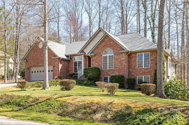 view of front of house with a garage, driveway, brick siding, and a front lawn