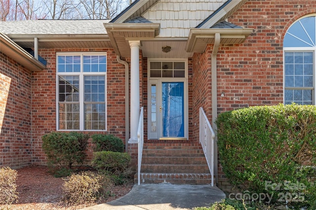 property entrance with brick siding