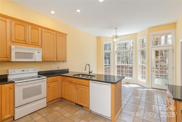 kitchen with light brown cabinetry, a sink, recessed lighting, white appliances, and a peninsula