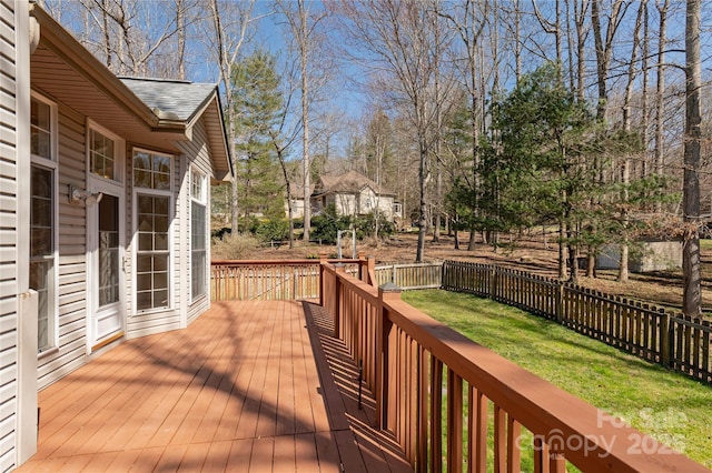 deck with a yard and fence