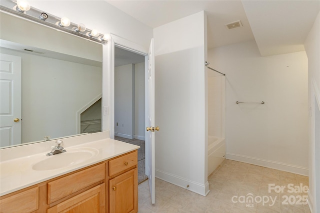 bathroom featuring visible vents, vanity, bathing tub / shower combination, and baseboards