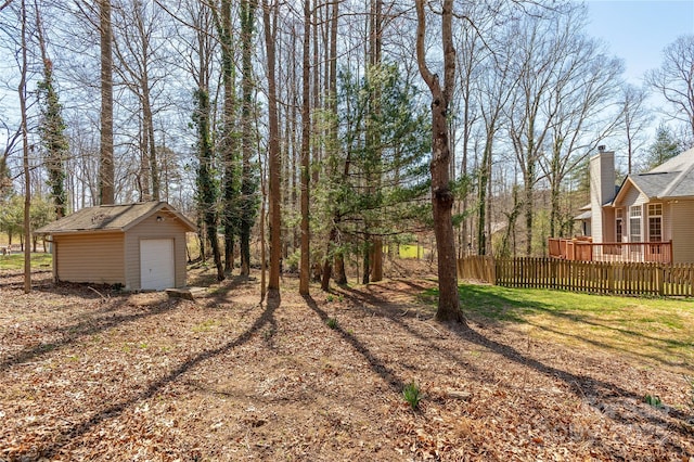 view of yard with an outbuilding and fence