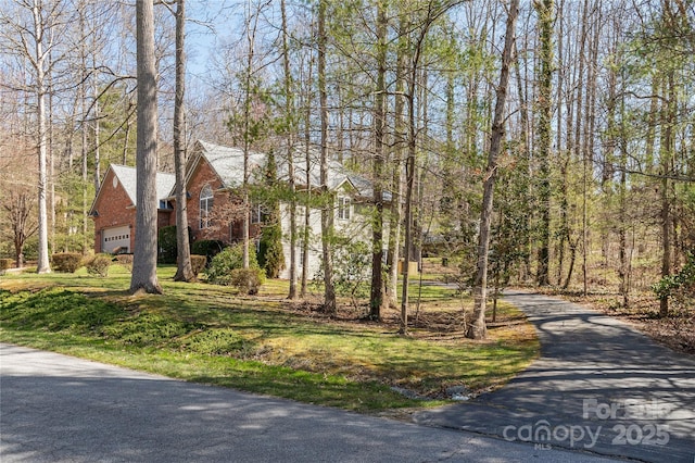 view of front of house featuring aphalt driveway and a garage