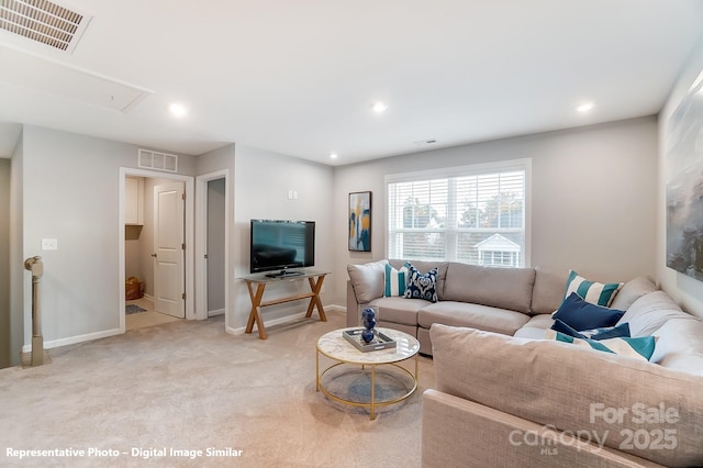 living room with light carpet, recessed lighting, visible vents, and attic access