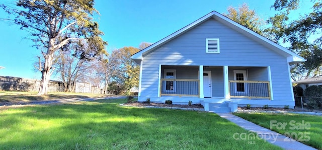 bungalow-style home with a front lawn and a porch