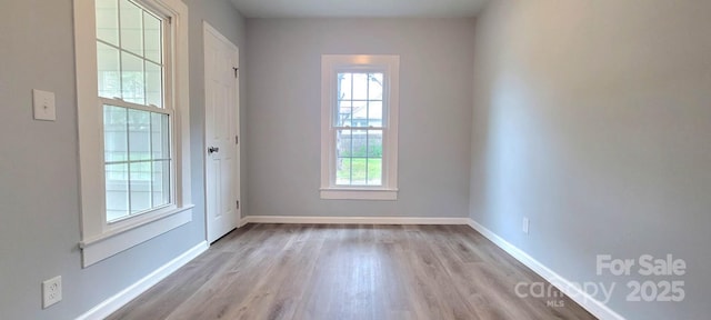 entryway with light wood-style flooring and baseboards