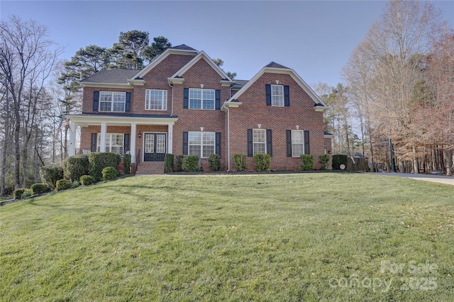 view of front of home featuring brick siding and a front yard