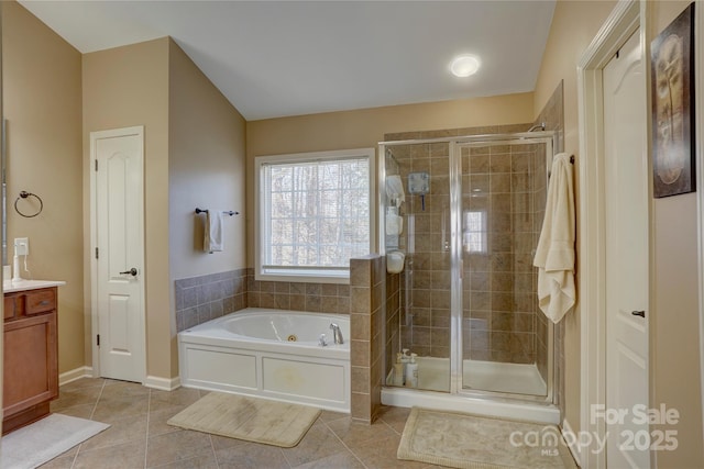 bathroom with tile patterned floors, a garden tub, a stall shower, and vanity