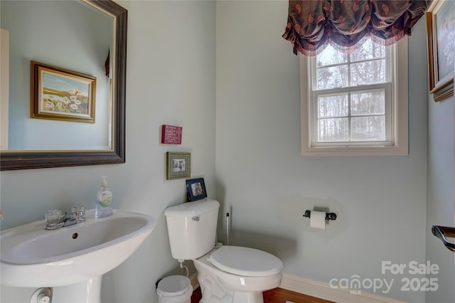 bathroom with toilet and a sink