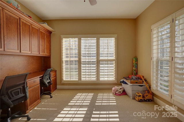 office area featuring ceiling fan and light carpet