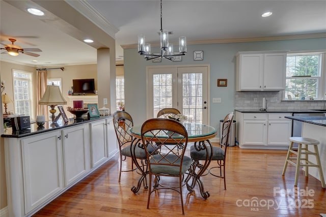 dining space with recessed lighting, light wood-style flooring, and crown molding