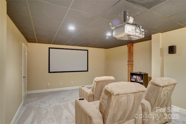 home theater room with carpet flooring, baseboards, and a drop ceiling