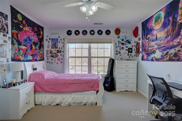 carpeted bedroom featuring visible vents and ceiling fan