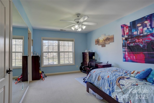 carpeted bedroom featuring a ceiling fan, multiple windows, baseboards, and visible vents