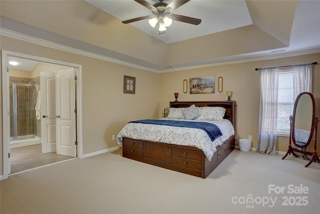 bedroom featuring a tray ceiling, baseboards, ornamental molding, and carpet flooring