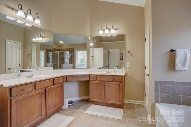 full bathroom featuring tile patterned floors, a shower stall, baseboards, a bath, and vanity