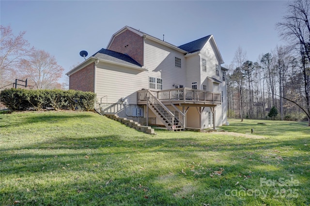 back of house featuring a deck, stairway, a yard, and brick siding