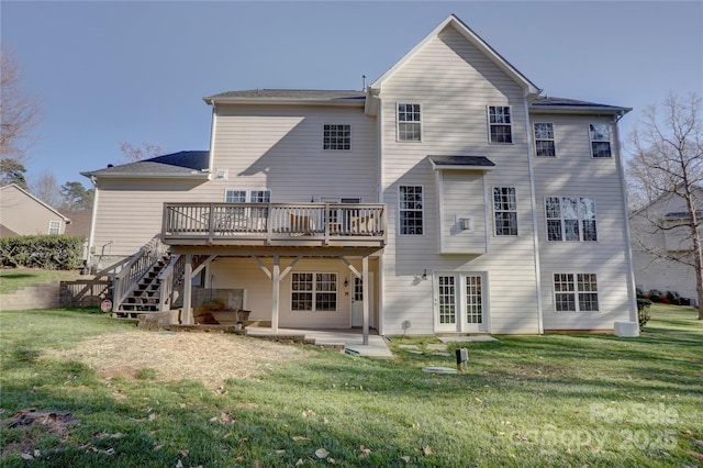 rear view of property with a patio area, stairway, a lawn, and a wooden deck