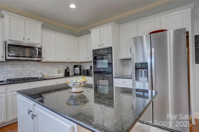 15100 Durmast Ct, Mint Hill, NC 28227 - kitchen with appliances with stainless steel finishes, white cabinetry, and a kitchen island