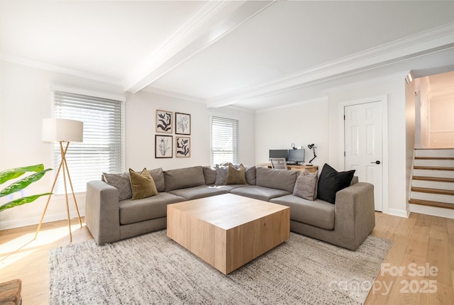 living area with beam ceiling, light wood-style floors, stairs, and crown molding