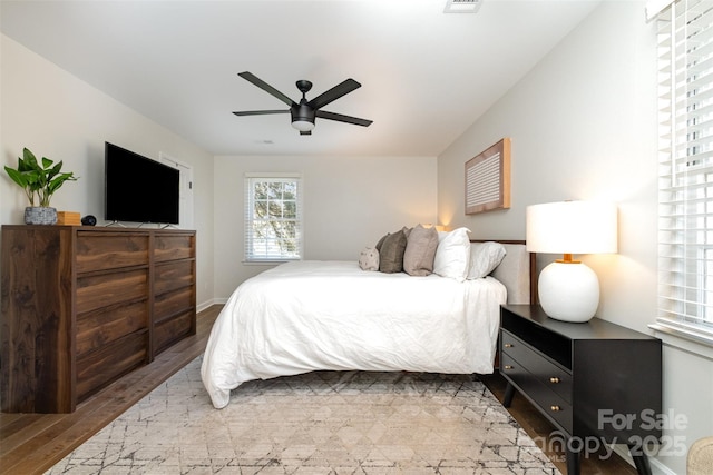 bedroom featuring visible vents, wood finished floors, and a ceiling fan