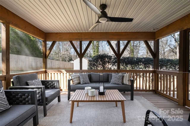 exterior space featuring an outbuilding, a fenced backyard, ceiling fan, a storage shed, and an outdoor hangout area