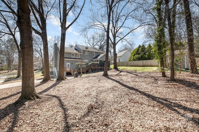 view of yard with a wooden deck and fence