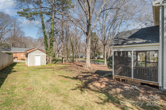 view of yard with an outbuilding, a sunroom, and a shed