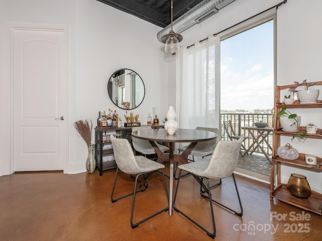 dining room with concrete flooring