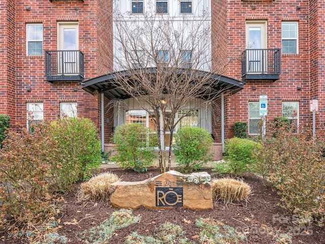 view of exterior entry with brick siding